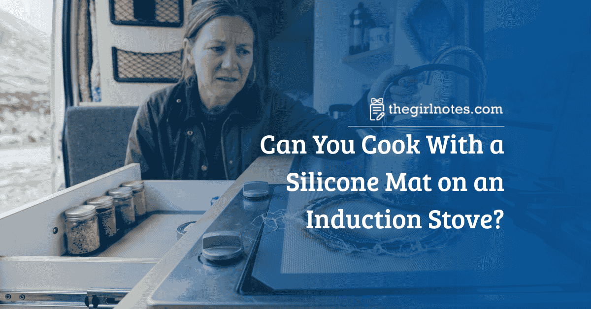 A woman in a camper van looks dismayed at a melted induction mat and scorched kettle.